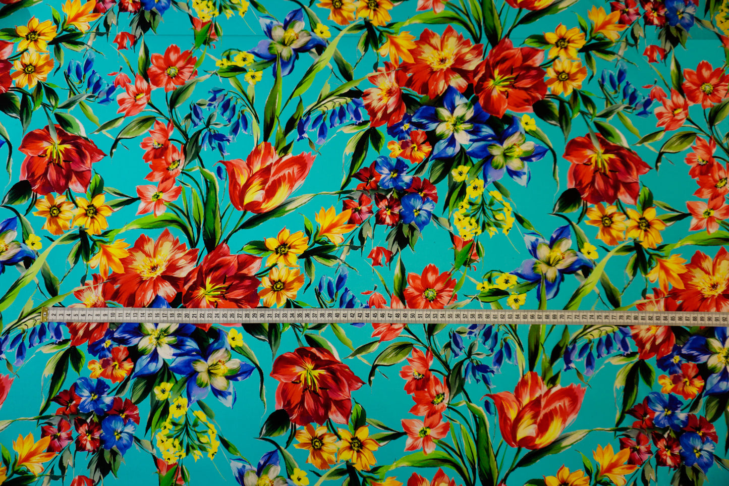 Silk crepe – floral print in bold colors on blue-turquoise