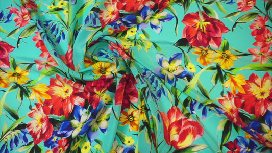 Silk crepe – floral print in bold colors on blue-turquoise