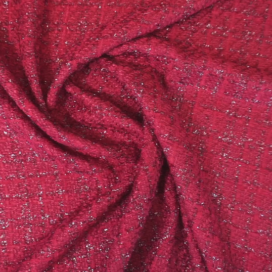 Rubinroter Bouclé-Stoff mit funkelnden Lurex-Akzenten und plastischer Struktur bei Bewegung